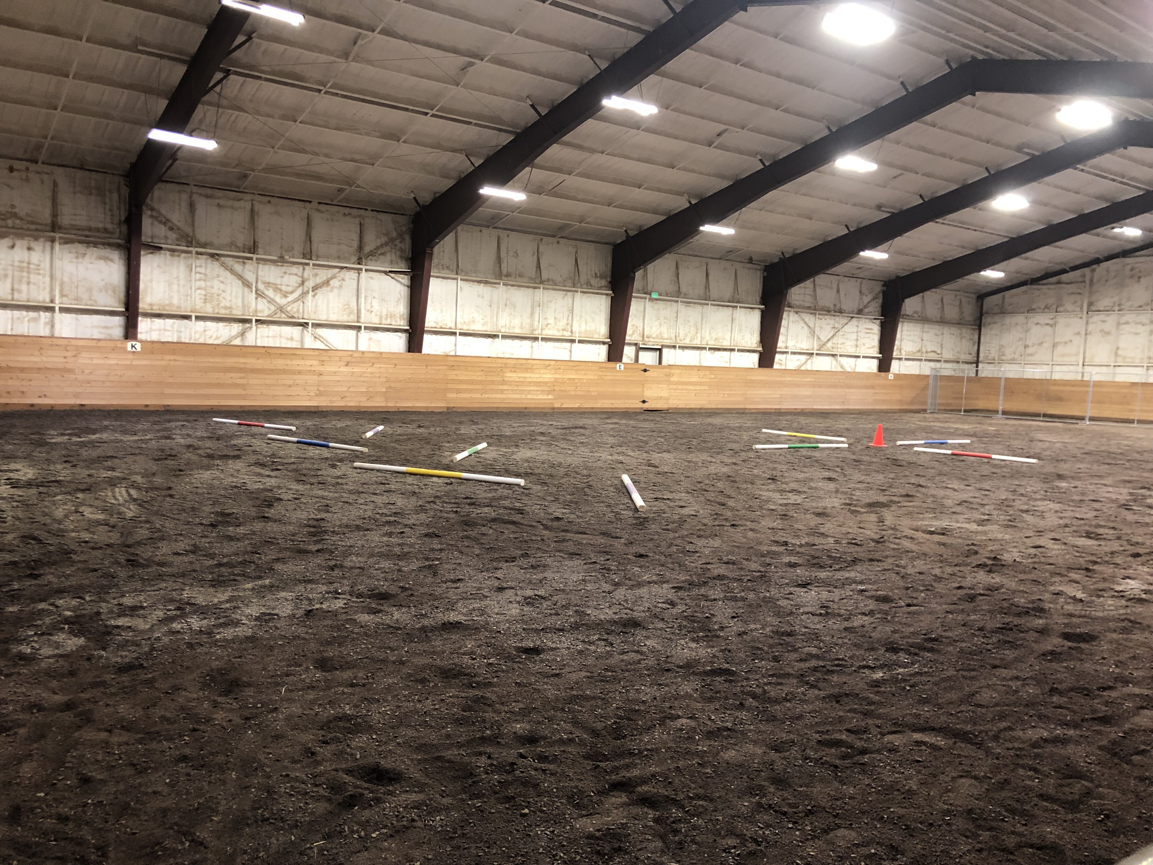 Indoor riding arena with poles